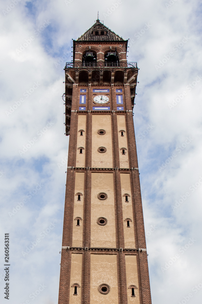 Bell tower in Mede (PV), with cloudy sky on background