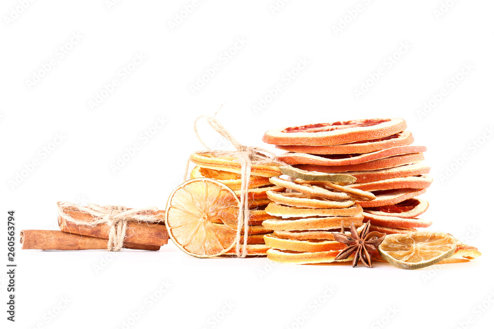 Dried citrus fruits with cinnamon and star anise on white background