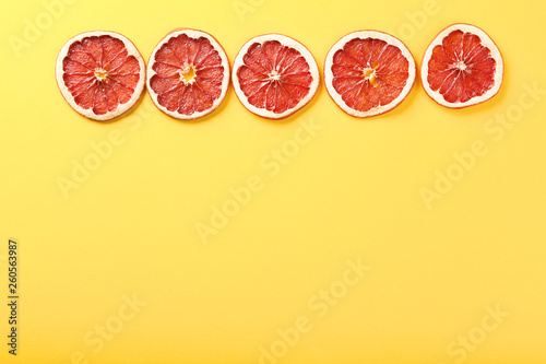 Dried grapefruits on yellow background