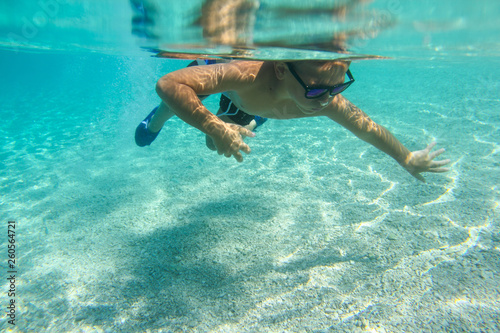 Boy diving swimming underwater view