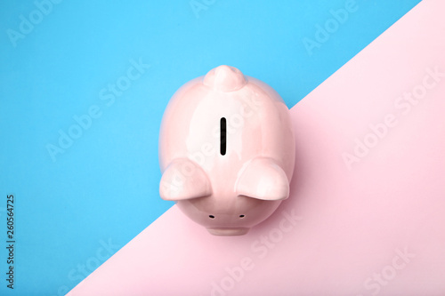 Pink piggy bank on colorful background