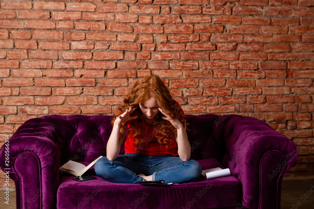 Obraz premium Female student gets tired of education and exams.