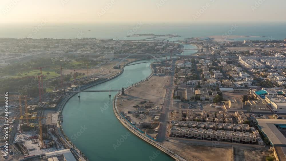 Luxury Dubai Marina canal with passing boats and promenade with restaurants night timelapse, Top view from above with illuminated skyscrapers. Dubai, United Arab Emirates Luxury Dubai Marina canal with passing boats and promenade with restaurants night timelapse, Top view from above with illuminated skyscrapers. Dubai, United Arab Emirates