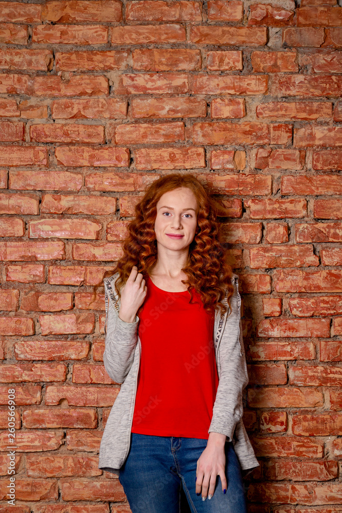 Red hair woman in sportive clothes posing. Red hair woman in sportive clothes posing.