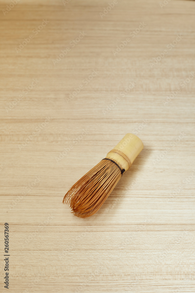 Bamboo tea whisk for matcha on wooden table