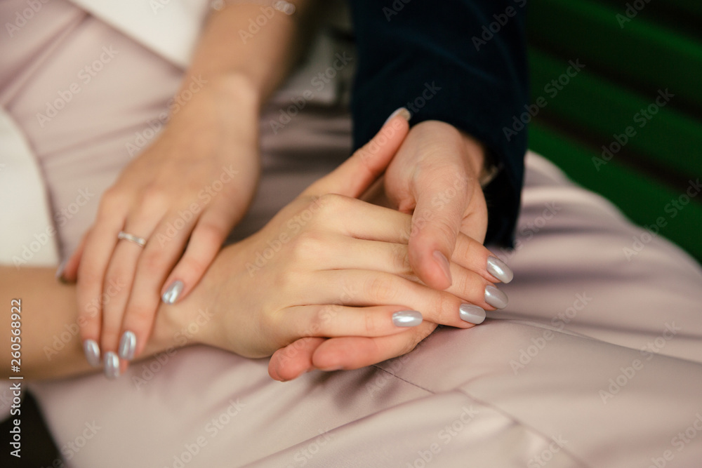 Close-up hands with a neat french manicure. Rings on the fingers. Gentle fresh morning hands. Close-up hands with a neat french manicure. Rings on the fingers. Gentle fresh morning hands.