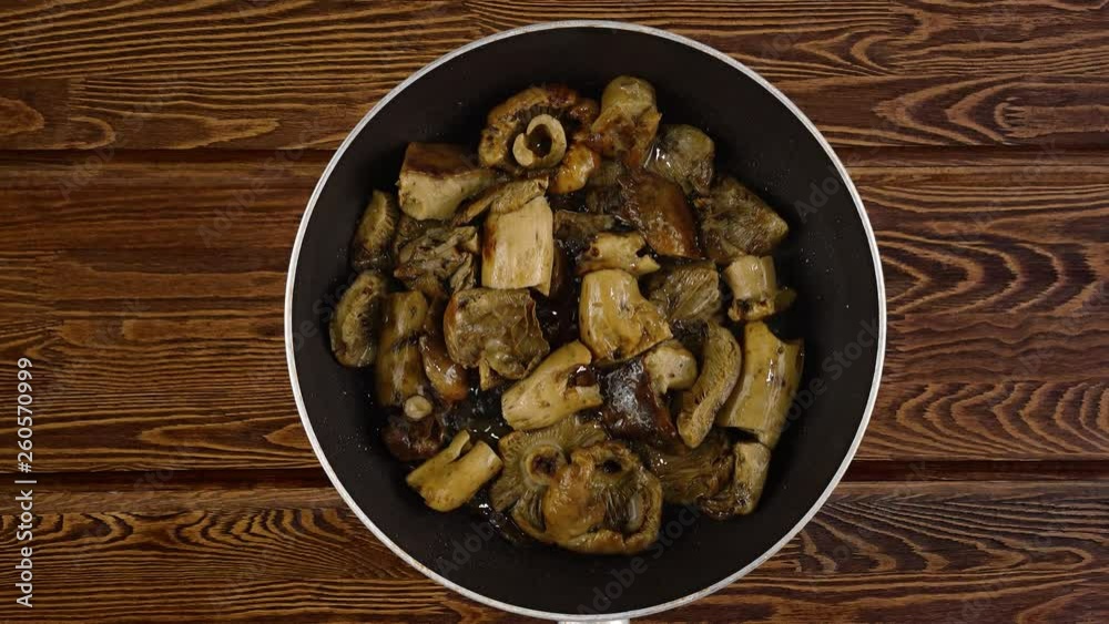 Cooking food concept. The cook fry the mushrooms in a frying pan. Cooking food concept. The cook fry the mushrooms in a frying pan.