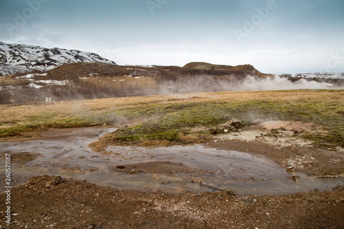 Steam rising from geyser fumarole volcanic lava field panorama Iceland