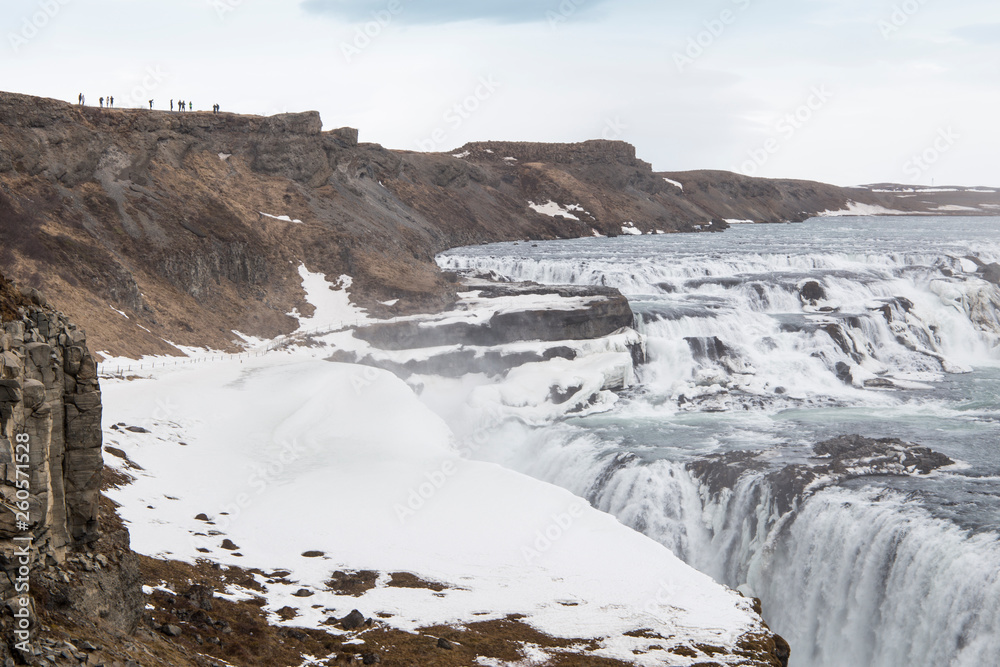 Amazing Icelandic winter landscape of majestic waterfall of frozen Gullfoss Amazing Icelandic winter landscape of majestic waterfall of frozen Gullfoss