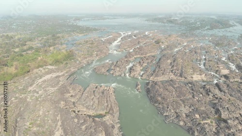 Aerial: flying over Don Det and the 4000 islands Mekong River in Laos, Li Phi waterfall, famous tourist destination in South East Asia, stunning landscape. Native cinelike D-log color profile photo