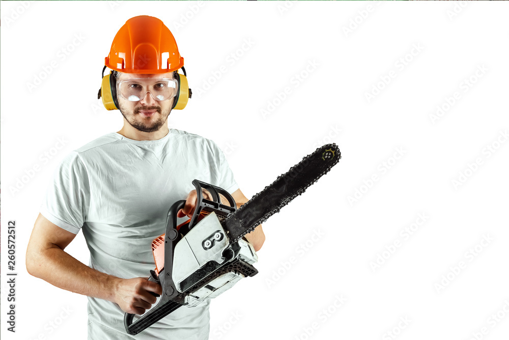 A bearded man in a helmet holding a chainsaw on a white background. Concept building, contractor, repair, lumberjack.