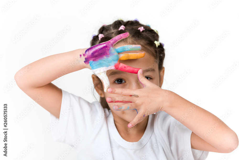 cute little child girl with hands painted in colorful paint isolated on white background. cute little child girl with hands painted in colorful paint isolated on white background.