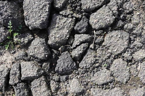 Fototapeta Naklejka Na Ścianę i Meble -  Detailed close up surface of asphalt on streets with small stones and cracks