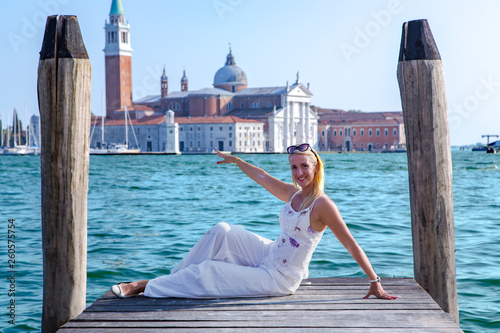 Happy beautiful girl against the background of turquoise water at the Grand Canal next St Marks Square in Venice, Italy.Concept of traveling and vacation in summer Venice.  © Tanya Keisha