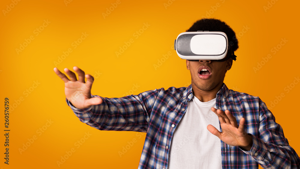 Guy experiencing with VR goggles, playing video games