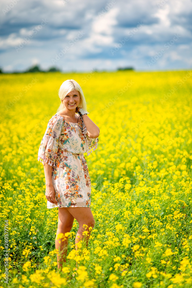 Soft, selective focus. Beautiful, attractive, blond woman in a yellow flower meadow. Soft, selective focus. Beautiful, attractive, blond woman in a yellow flower meadow.