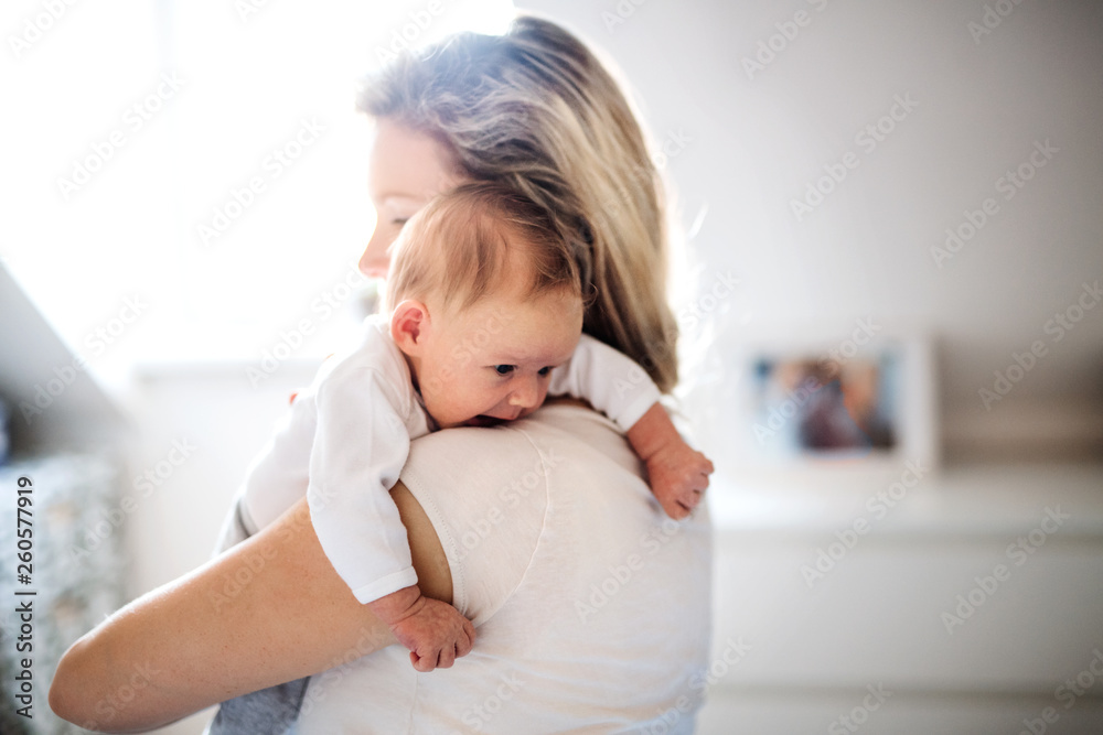 A beautiful young mother with a newborn baby at home. Copy space. A beautiful young mother with a newborn baby at home. Copy space.