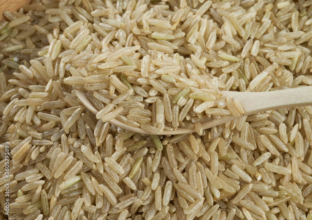Handful of brown unpeeled rice isolated on white background. Handful of brown unpeeled rice isolated on white background.