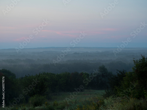 Photo fog over the forest in theearly morning.Beautiful place in nature, ecologically clean area. Traveling and Hiking, camping with the whole family. A great place for meditation, yoga and relaxation