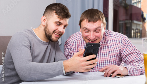 Photography Men with phone discussing at home