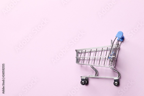 Shopping concept. shopping cart on a pink background.