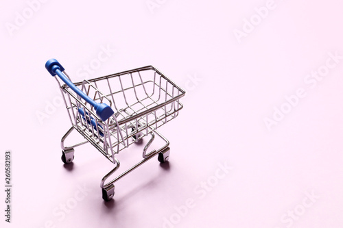 Shopping concept. shopping cart on a pink background.