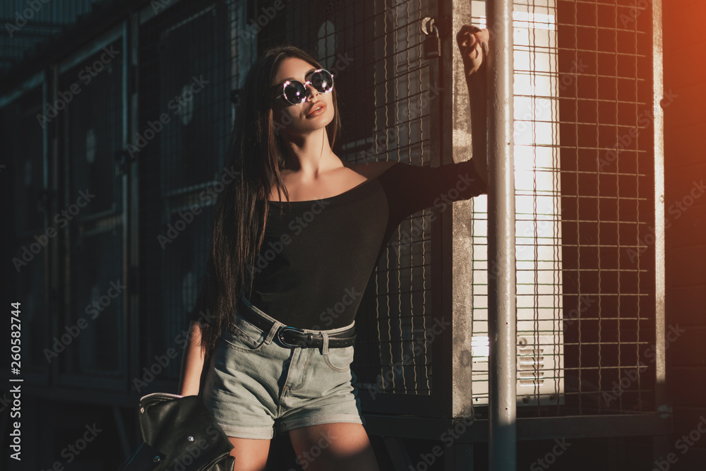 Pretty young sexy fashion model posing on the street. Pretty young sexy fashion model posing on the street.