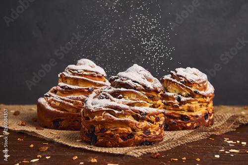 Tasty sweet buns with raisins and icing sugar. Homemade baking concept