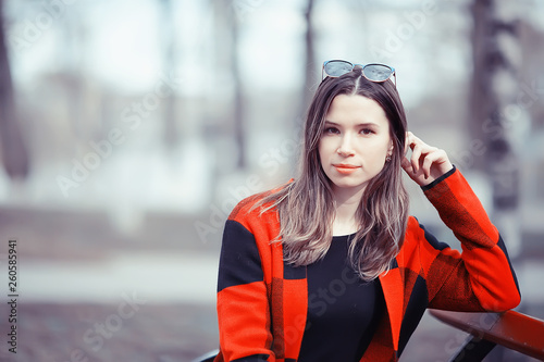 spring adult girl outdoor / March in Scotland, a girl in a plaid poses in the park