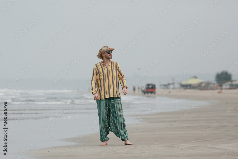 man on the beach in india, ocean, coast, vacation. rest on goa