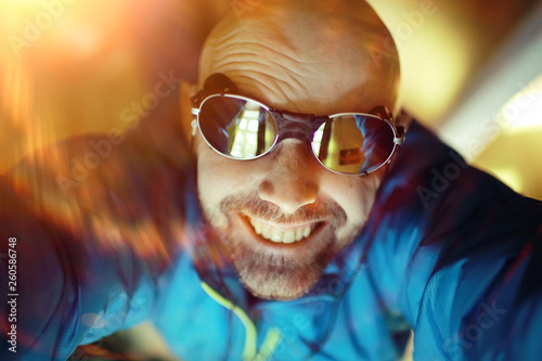 Tourist bearded man in sunglasses, sport tourism, concept active leisure, male tourism, portrait of a brutal man in sportswear, middle-aged man