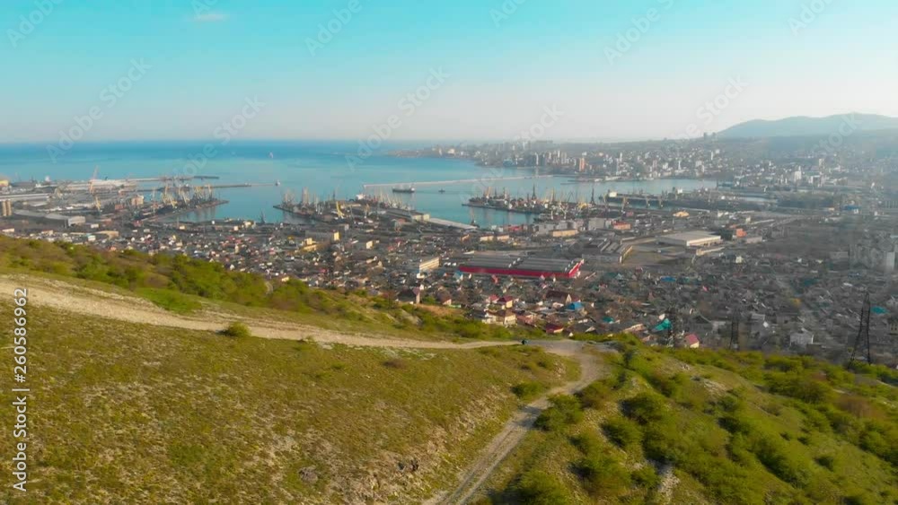 quadrocopter overflight of a tourist sitting on a mountain, shooting from a drone Novorossiysk port, Novorossiysk city, Russia, Cements Bay quadrocopter overflight of a tourist sitting on a mountain, shooting from a drone Novorossiysk port, Novorossiysk city, Russia, Cements Bay