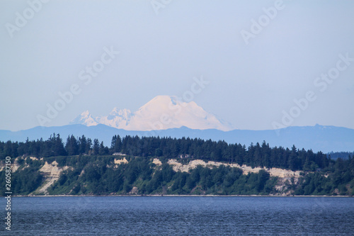 The snow capped mountain of Mt. Rainer in Washington from the water. © Joni