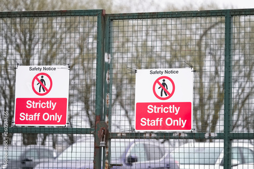 Strictly staff parking only sign on private office car park fence