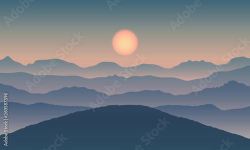 Landscape view with sun on mountain silhouettes.