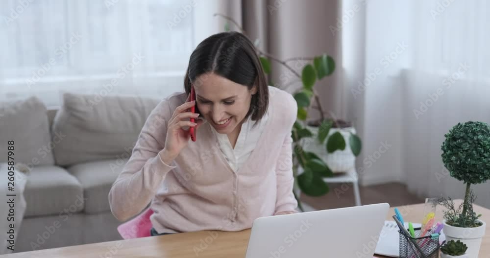 Businesswoman talking on mobile phone and using laptop Businesswoman talking on mobile phone and using laptop