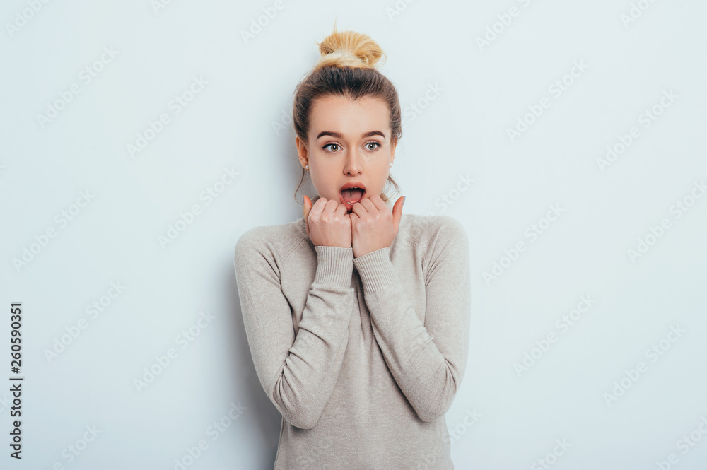 Shocked and surprised girl screaming covering mouth her hands. Beautiful girl with emotion on her face standing on isolated background. Expressive facial expressions Shocked and surprised girl screaming covering mouth her hands. Beautiful girl with emotion on her face standing on isolated background. Expressive facial expressions