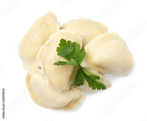 Tasty boiled dumplings with parsley on white background, top view