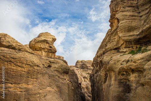canyon wilderness scenic landscape sand stone Middle East outdoor object foreshortening from below between bare steep rocks on blue sky background