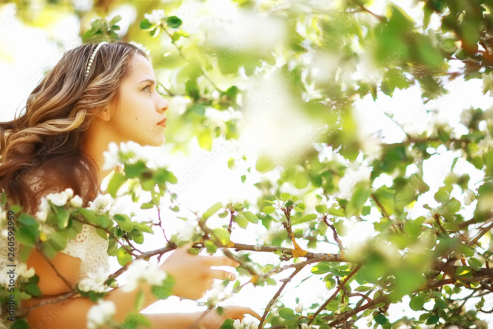light portrait of an apple tree, girl portrait of a high key, spring mood freshness and purity blonde with long hair in a blooming park in the spring light portrait of an apple tree, girl portrait of a high key, spring mood freshness and purity blonde with long hair in a blooming park in the spring