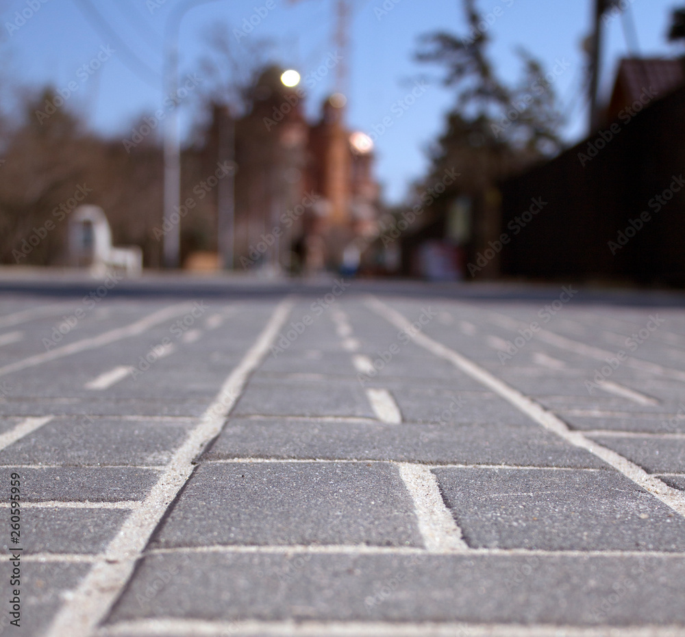 a road tiles of the Park close-up and of the Cathedral of Alexander Nevsky at the background 