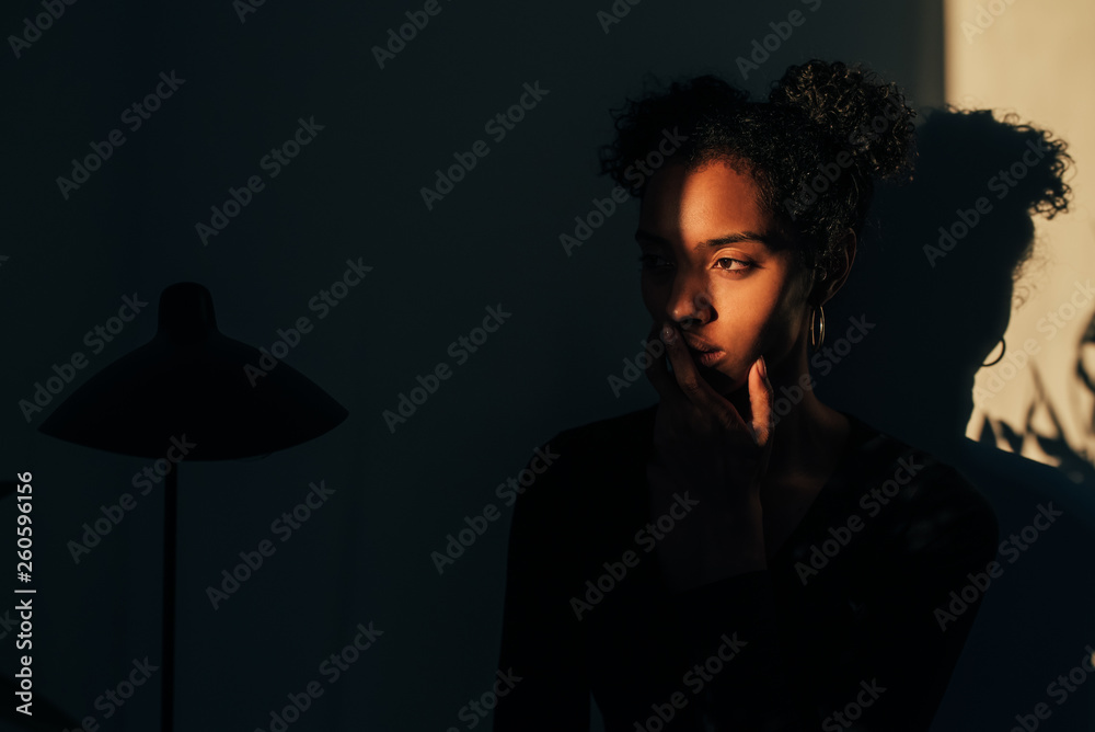 © DavidPrado - Woman standing near plant with shadow light © DavidPrado - Woman standing near plant with shadow light