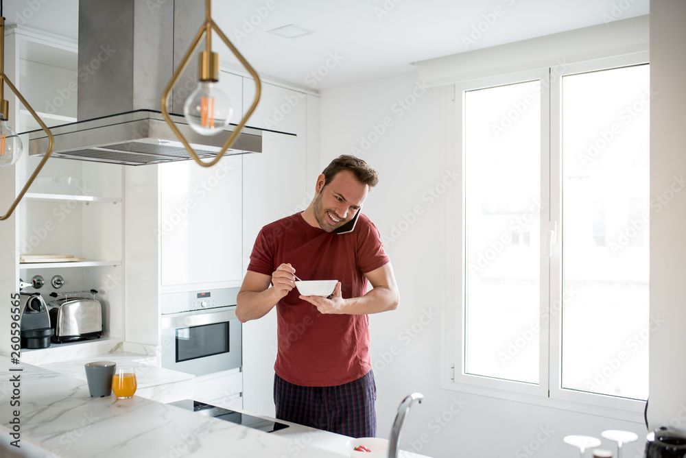 Man having breakfast with mobile phone Man having breakfast with mobile phone