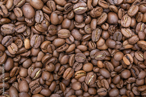 Brown roasted coffee beans, seed on dark background. Aroma, black caffeine drink. Closeup isolated energy mocha, cappuccino ingrediet. Flat lay.