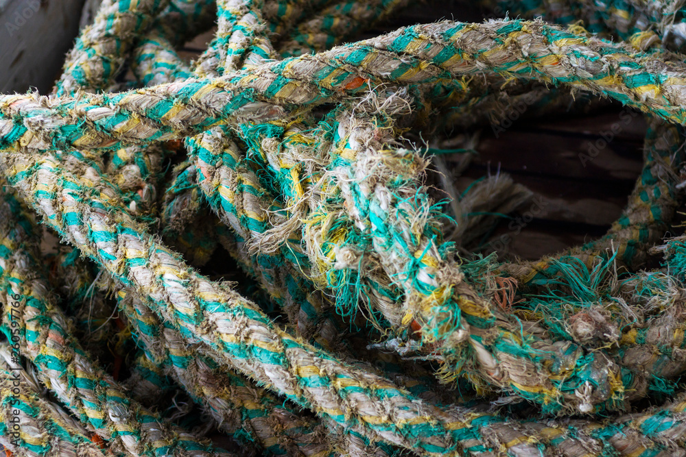 Ropes on Old Rusty Ship Closeup. Old Frayed Boat Rope as a Nautical Background. Naval Ropes on a Pier. Vintage Nautical Knots. Big Marine Sea Ship Ropes