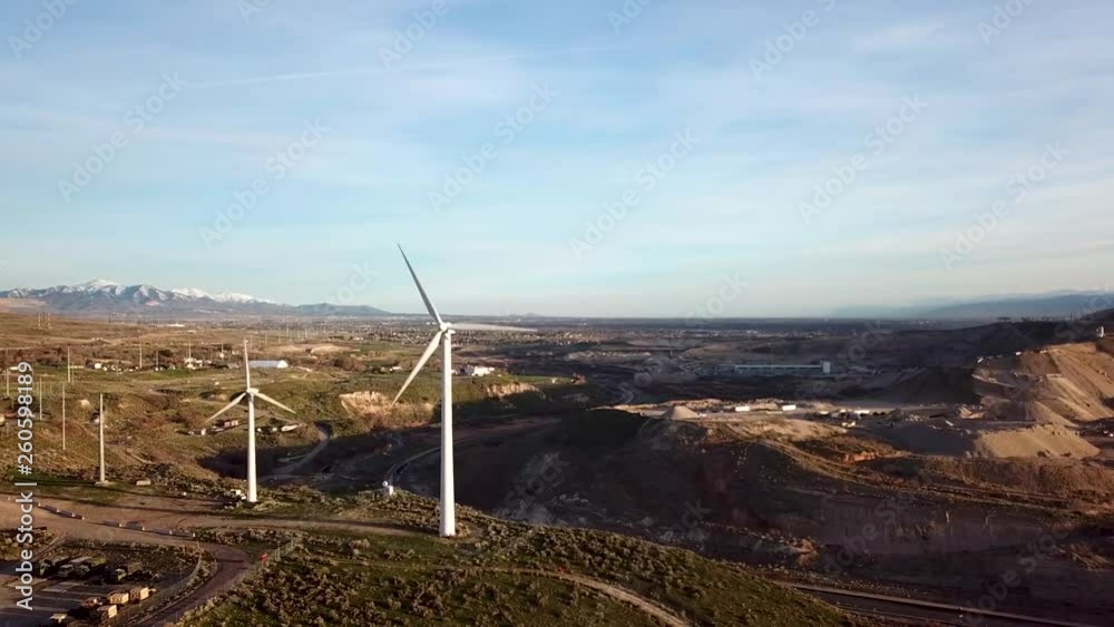 Wind turbines generating renewable power in a scenic setting - aerial view Wind turbines generating renewable power in a scenic setting - aerial view