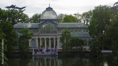 Madrid, Spain Parque de El Retiro Palacio de Cristal external lake view. Evening view of 1887 glasshouse Crystal Palace, before a lake at Buen Retiro Park in the Spanish capital.