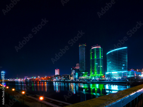 Colorful cityscape of Yekaterinburg at night reflecting in water