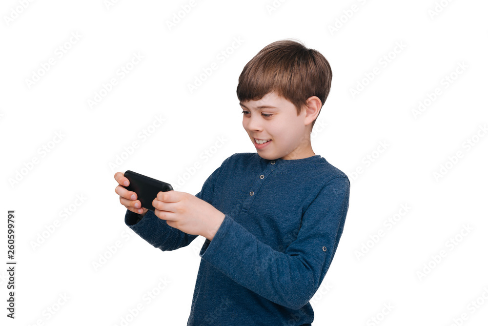 A little boy playing in smartphone, over isolated background A little boy playing in smartphone, over isolated background