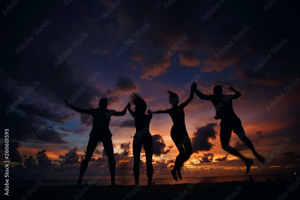 silhouettes of athletes running along the beach / sports summer in the warm sea, healthy rest, sports activity, summer vacation